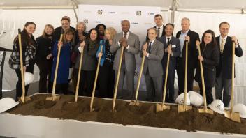 Image of a large group with shovels at the ceremonial groundbreaking of Aggie Square.