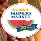 UC Davis Farmers Market 20th anniversary logo over photograph of peaches and apricots