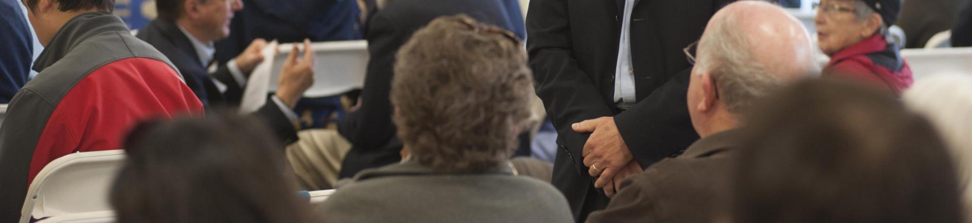 Image of Bob Segar interacting with university donors at a fundraising event.